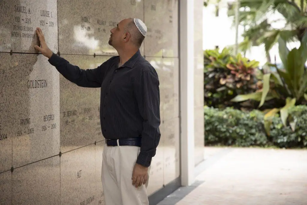 Man visiting a loved one at the Beth El Mausoleum