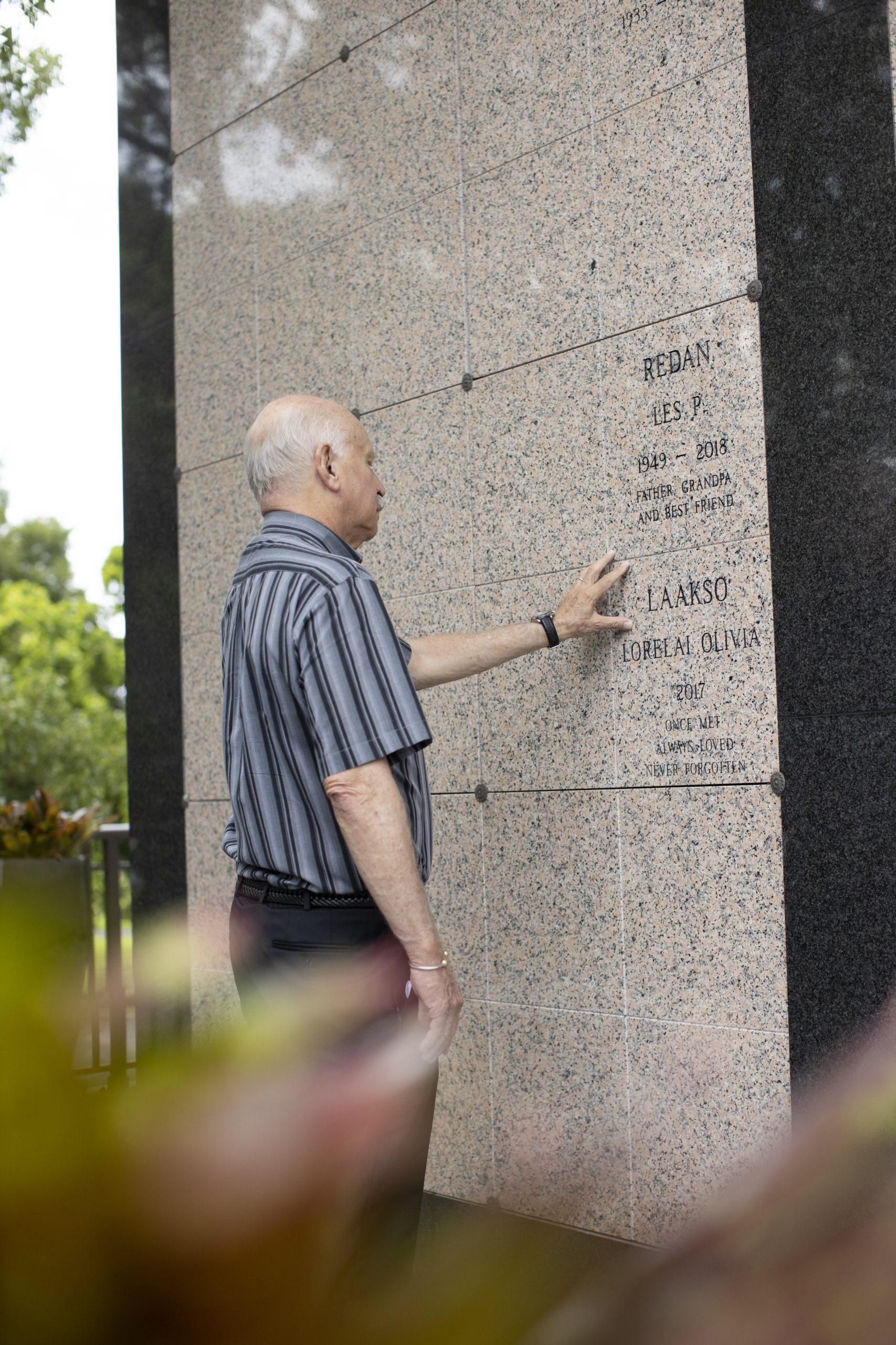 Man honoring a loved one in the outdoor area of the Beth El Mausoleum