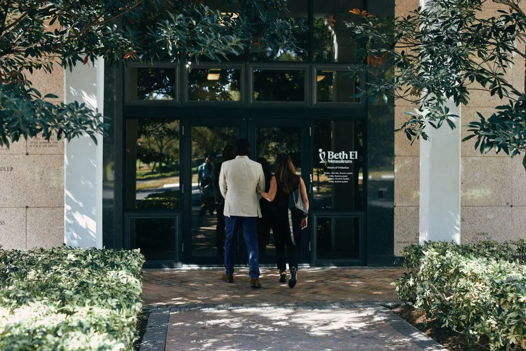 Two people walking into Beth El Mausoleum, located in Boca Raton, FL on the Temple Beth El site, a reform synagogue.